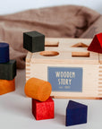 Handgefertigte Sortierbox Aus FSC-Zertifiziertem Holz Mit 7 Geometrischen Formen Für Kinder Ab 1 Jahr Lothi Regenbogen